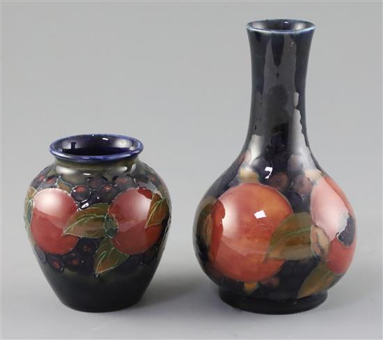 Two Moorcroft pomegranate vases, c.1918-26, H.9cm and 15.3cm, bottle vase broken and restuck at neck